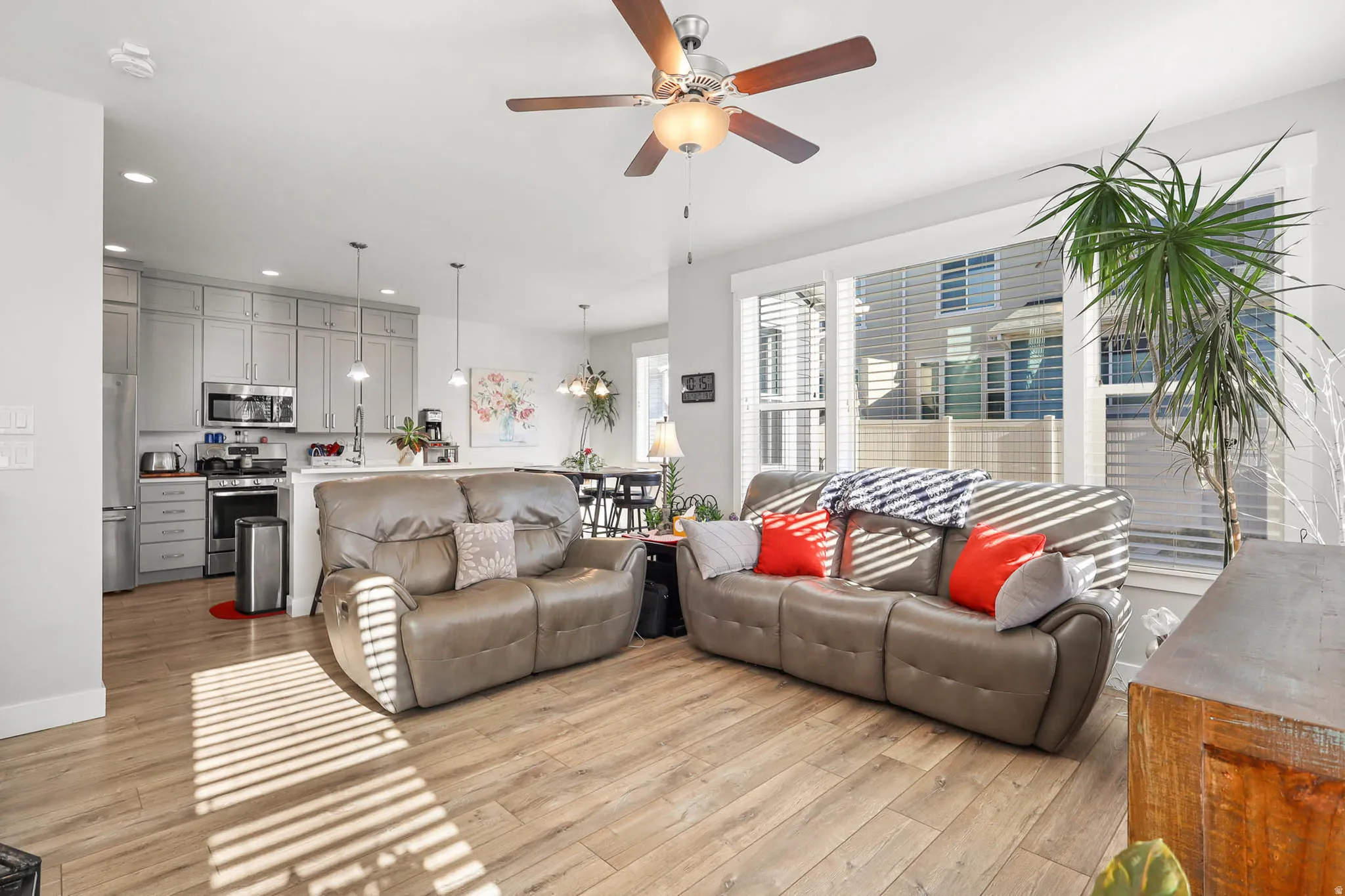 Living area with a ceiling fan, recessed lighting, and light wood-type flooring