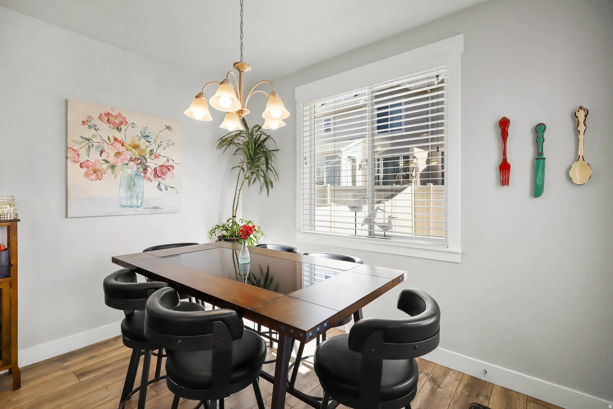 Dining room with wood finished floors and suspended lighting