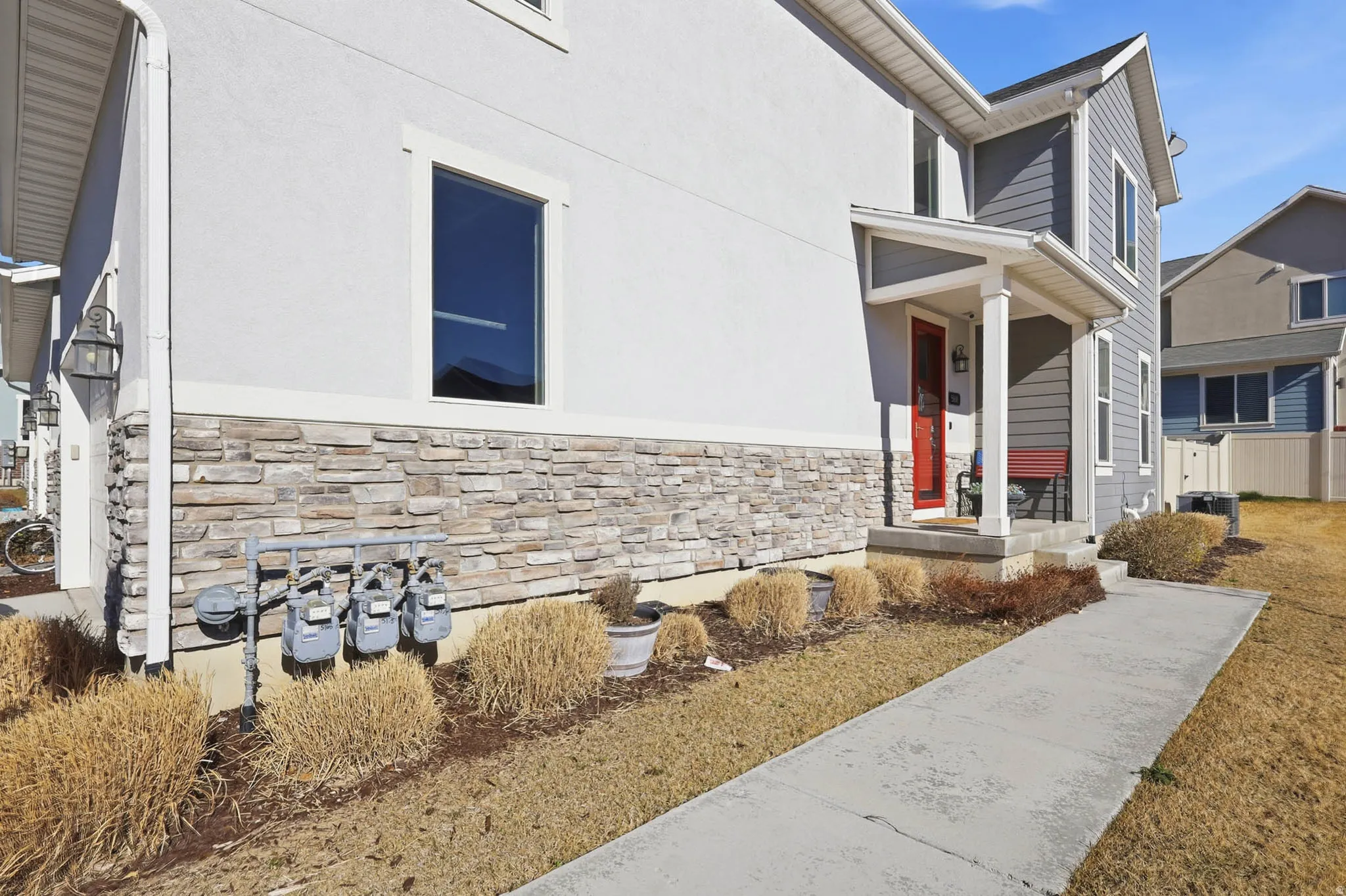 View of exterior entry featuring stone siding and stucco siding