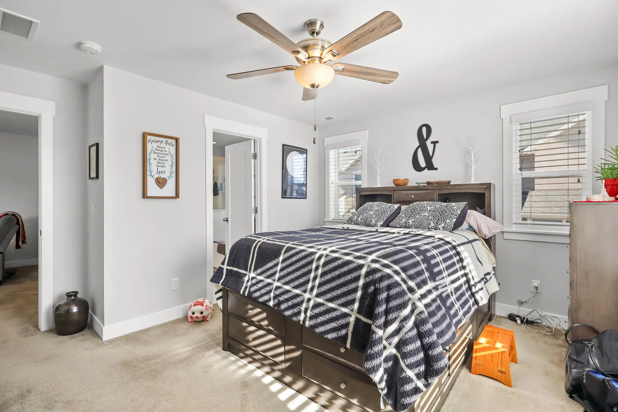 Bedroom featuring light colored carpet and ceiling fan