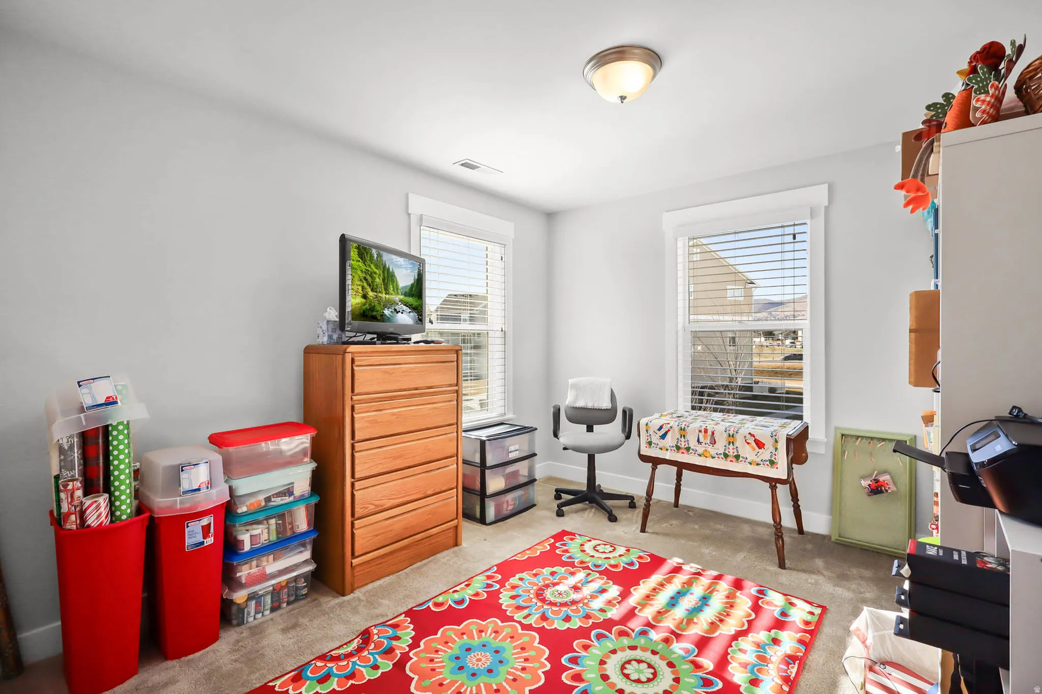 Recreation room featuring baseboards and light colored carpet