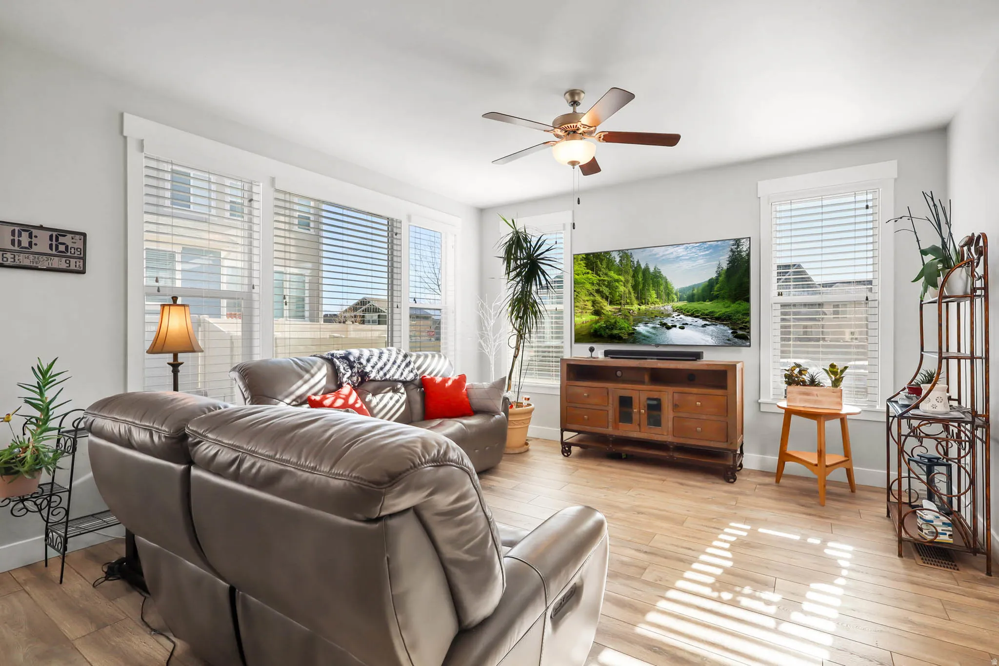 Living room featuring a ceiling fan and light wood finished floors