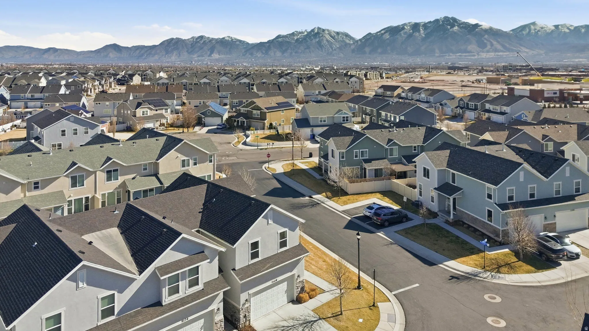 Aerial perspective of suburban area with a mountain backdrop