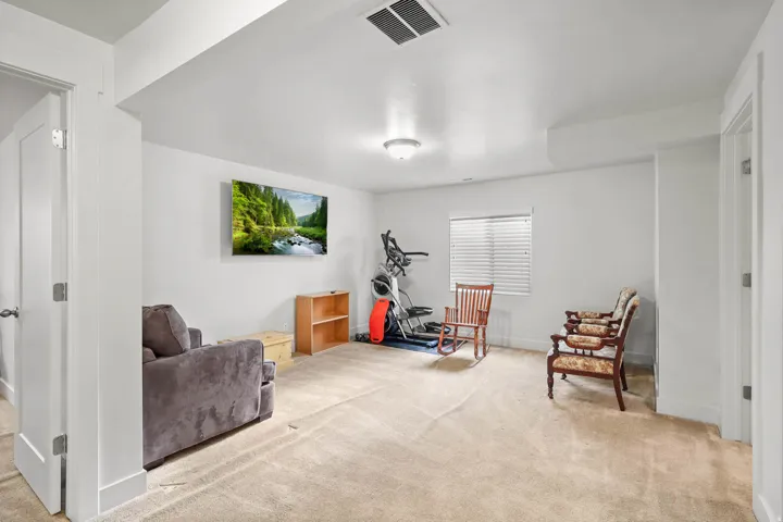 Living area featuring light carpet and baseboards