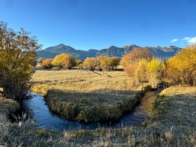 View of mountain backdrop with a nearby body of water