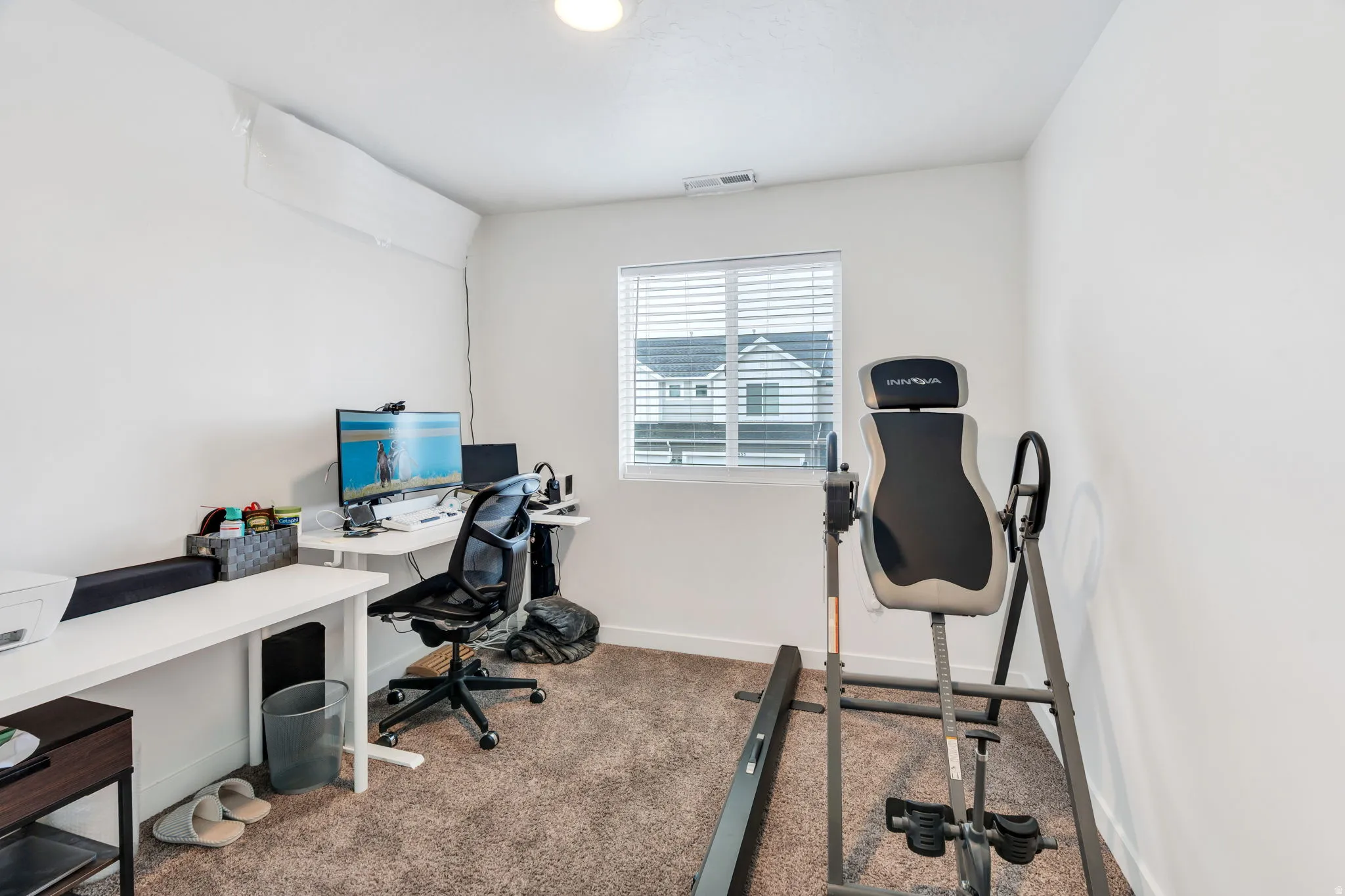 Office space with dark carpet and baseboards
