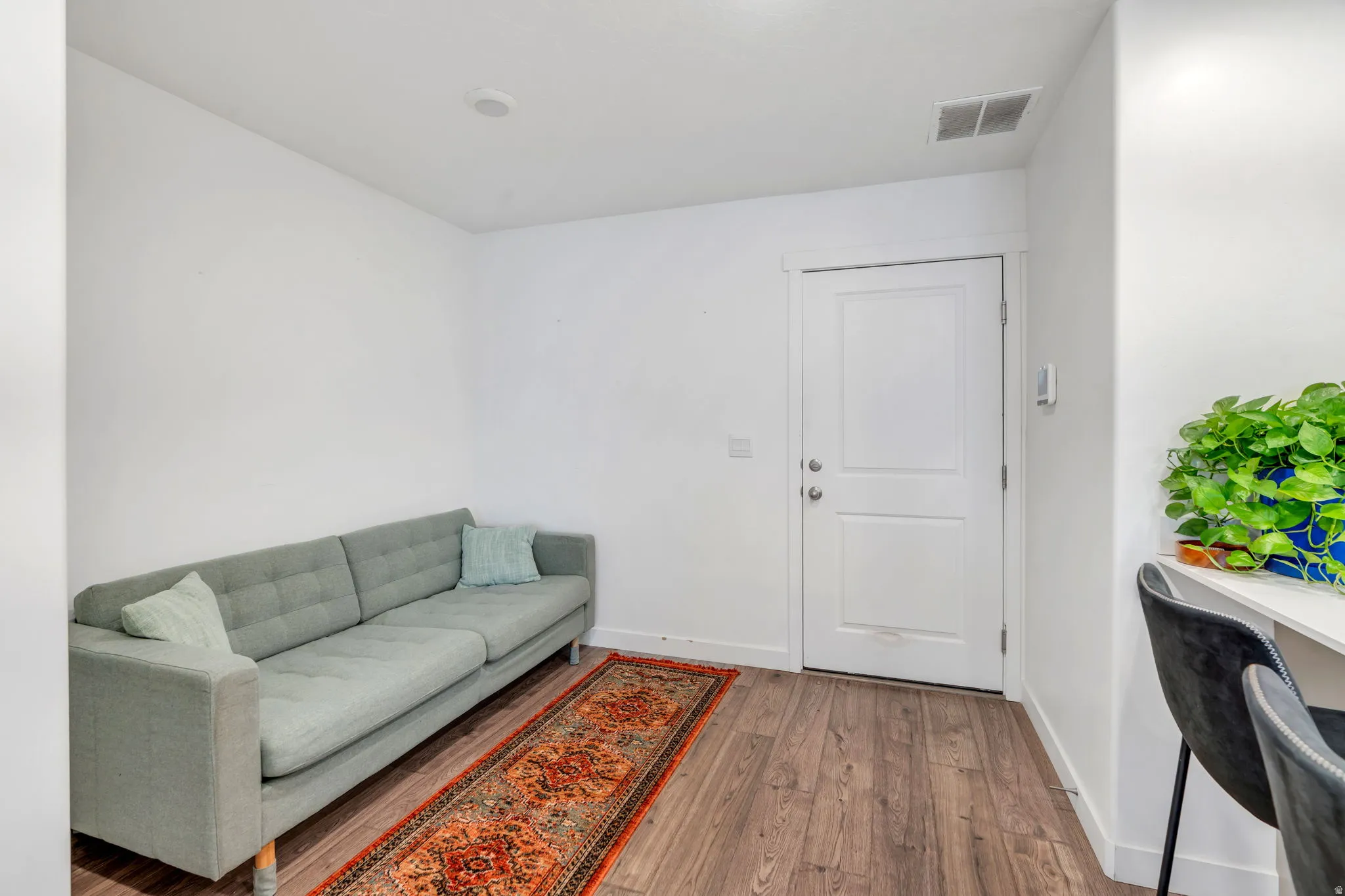 Some use this as a chilling area, some would put a small dining table here, right by the door to the garage.