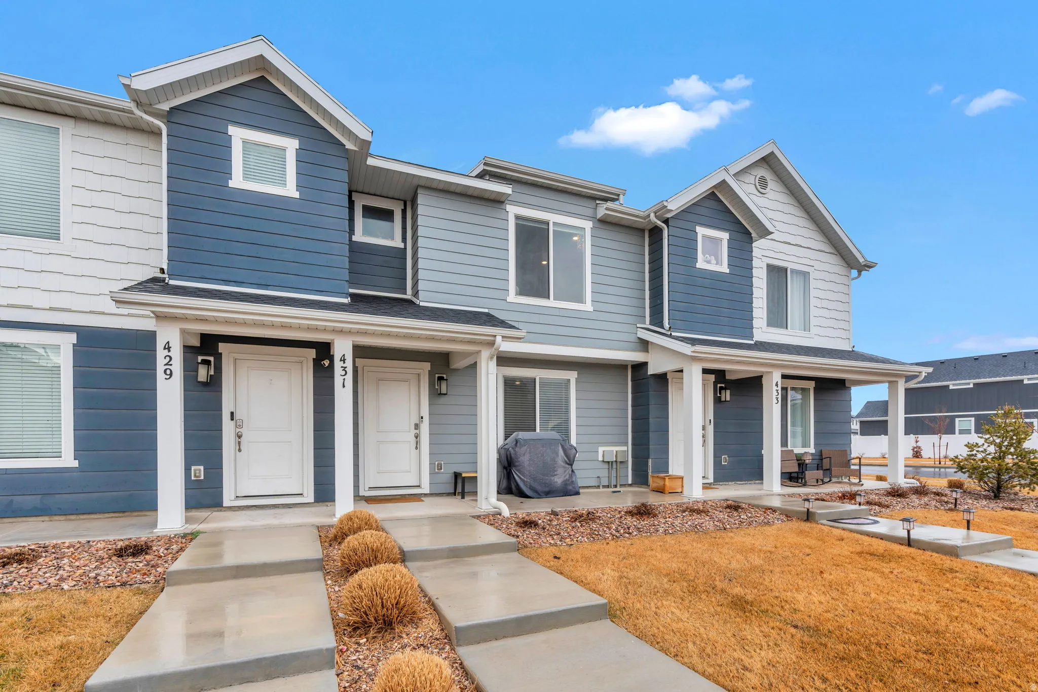 View of front of home with a porch and a front lawn