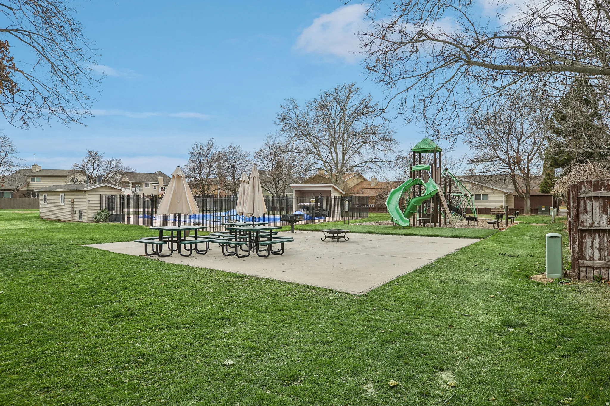 Communal playground featuring a residential view and a patio
