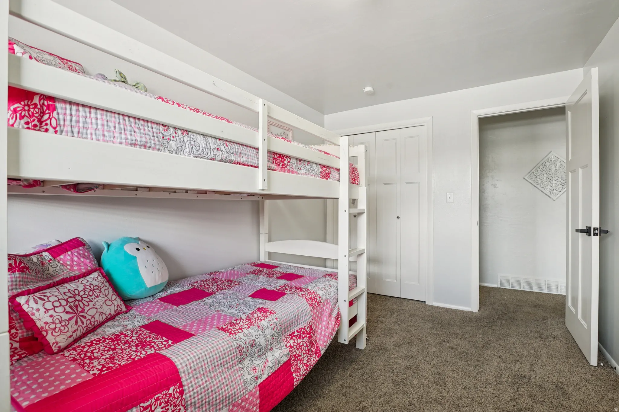 Bedroom featuring dark colored carpet and a closet