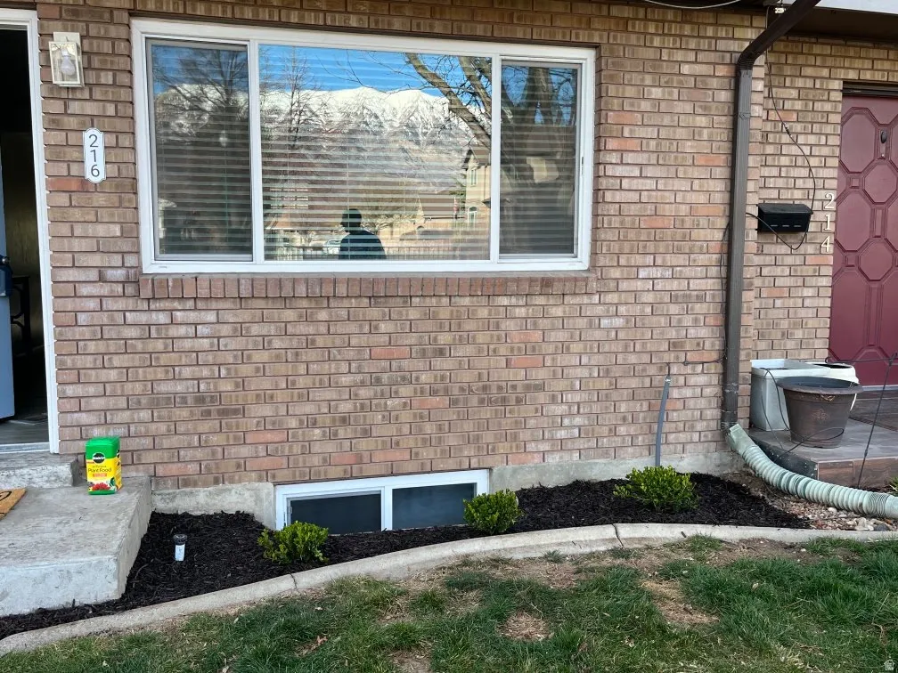 Exterior view of brick siding and a wood stove
