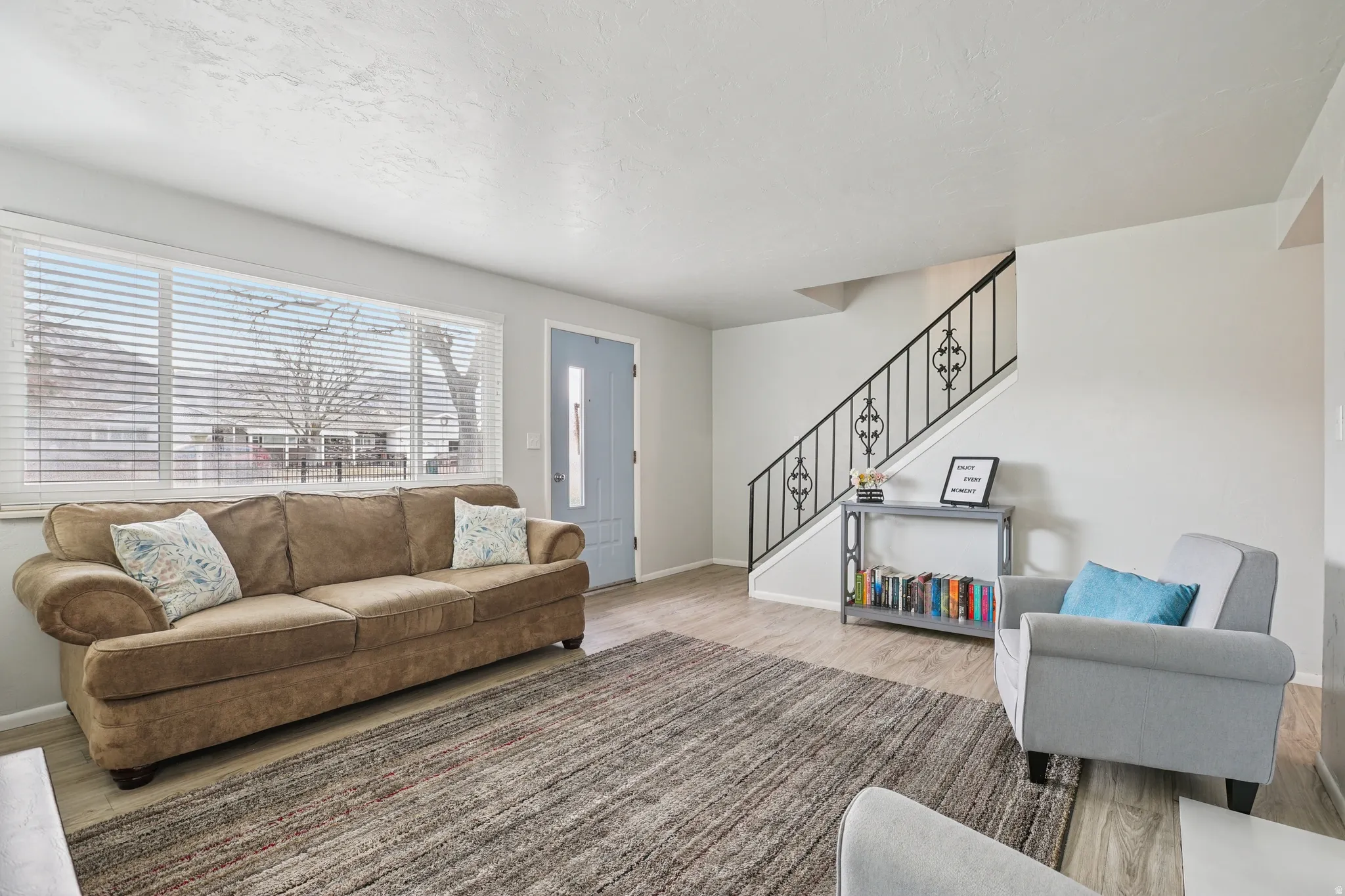 Living room featuring stairway and wood finished floors