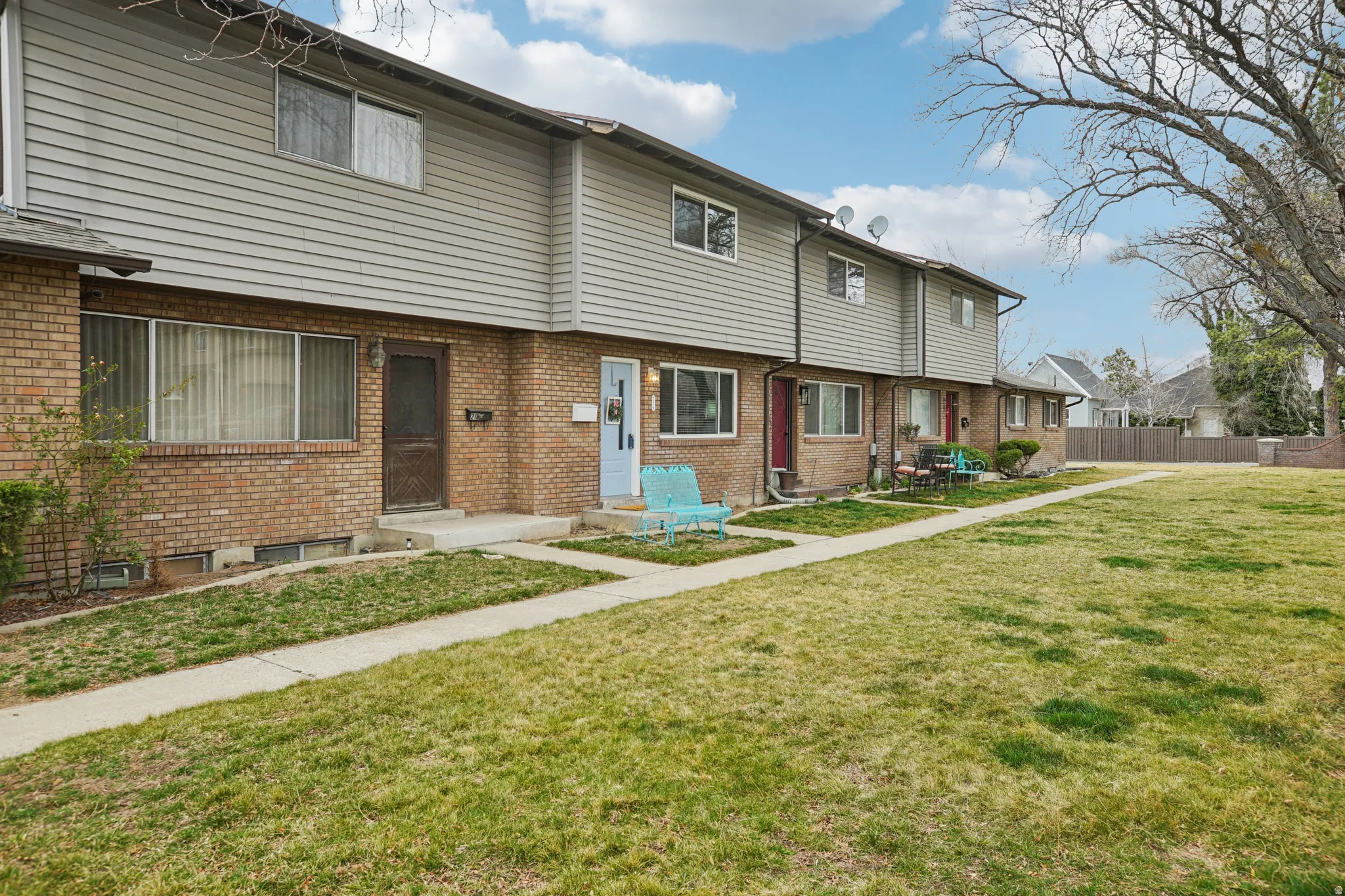 Colonial-style house with brick siding and entry steps