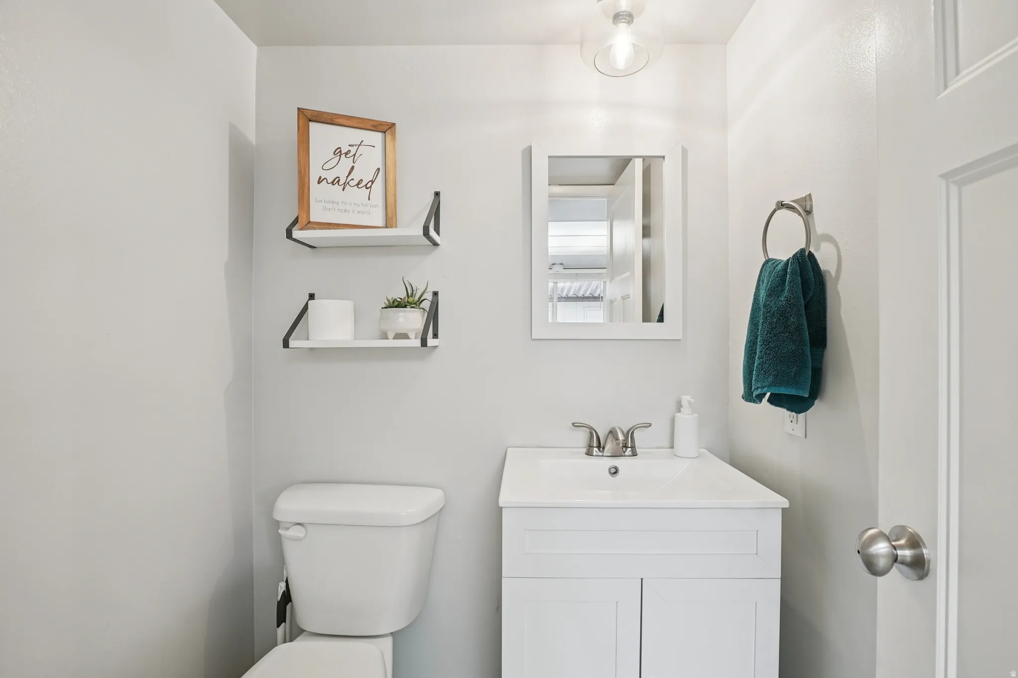 Half bathroom featuring toilet and vanity
