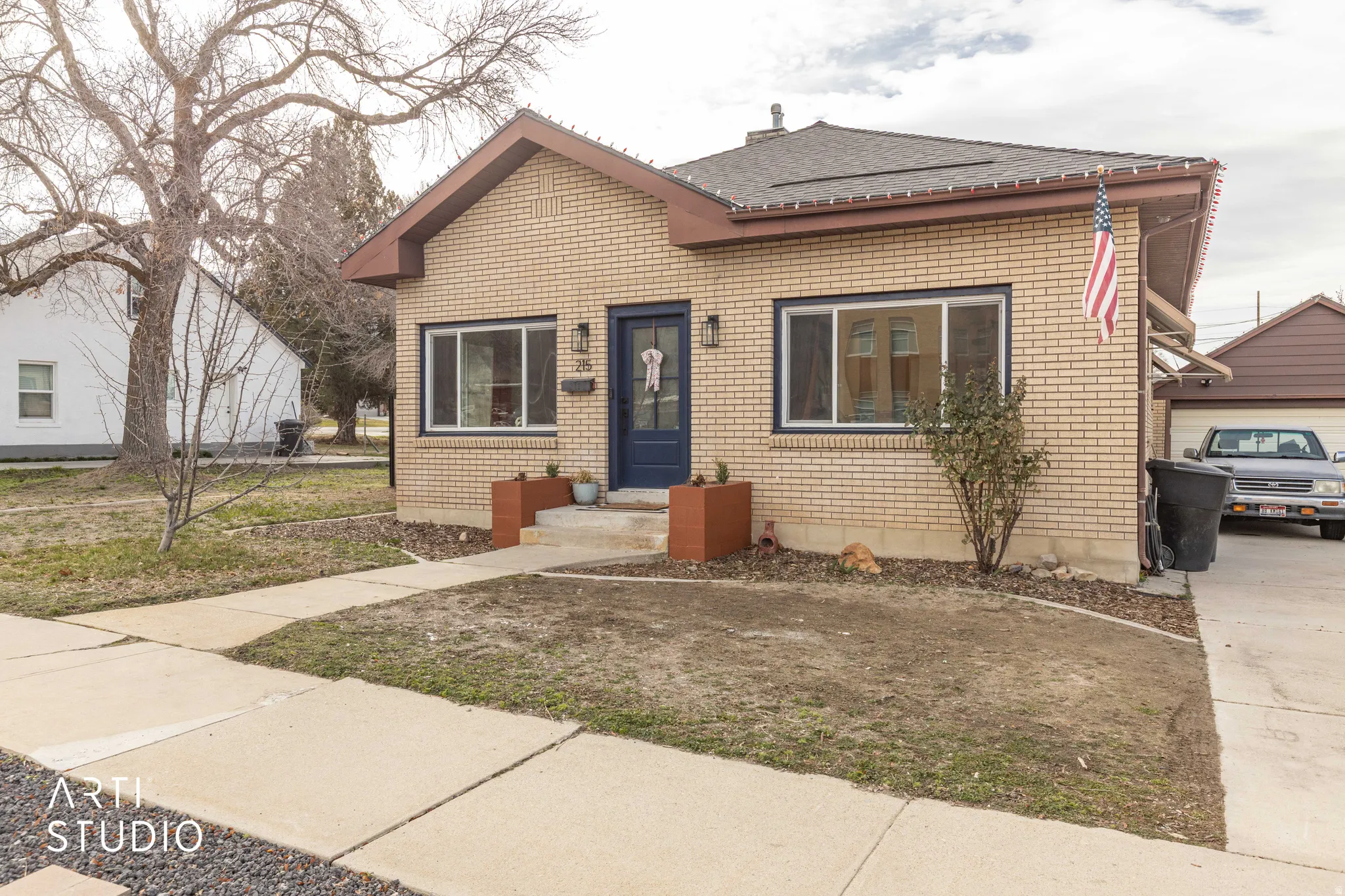 Bungalow-style home featuring brick siding and roof with shingles