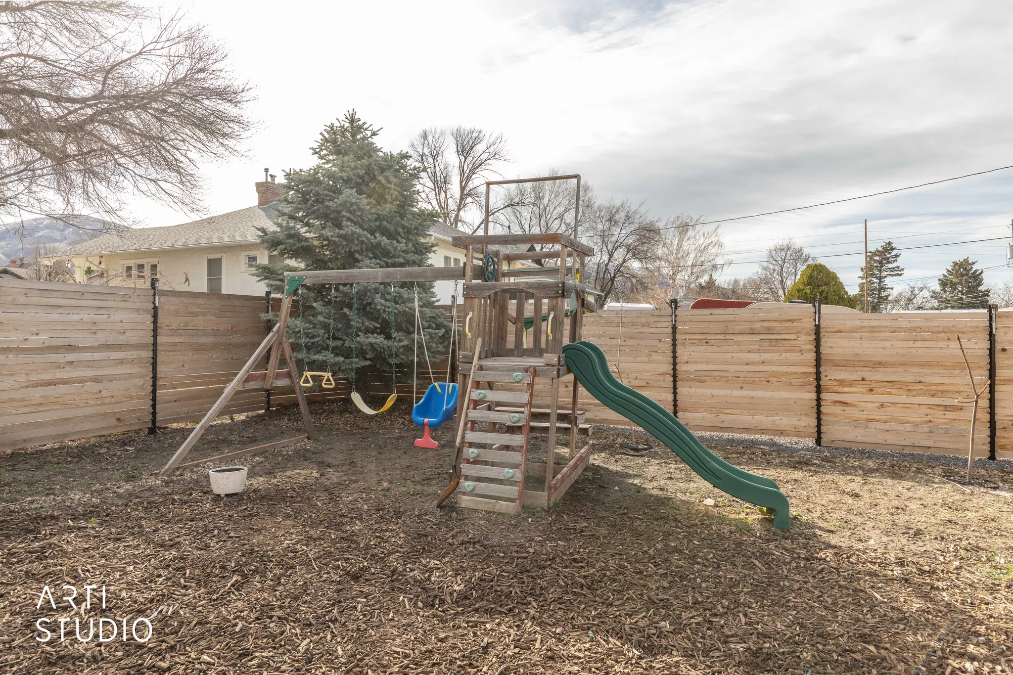 View of play area with a fenced backyard