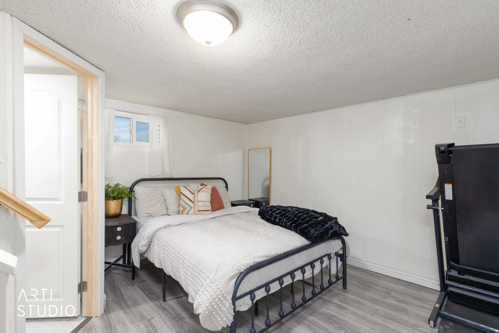 Bedroom featuring light wood finished floors and a textured ceiling