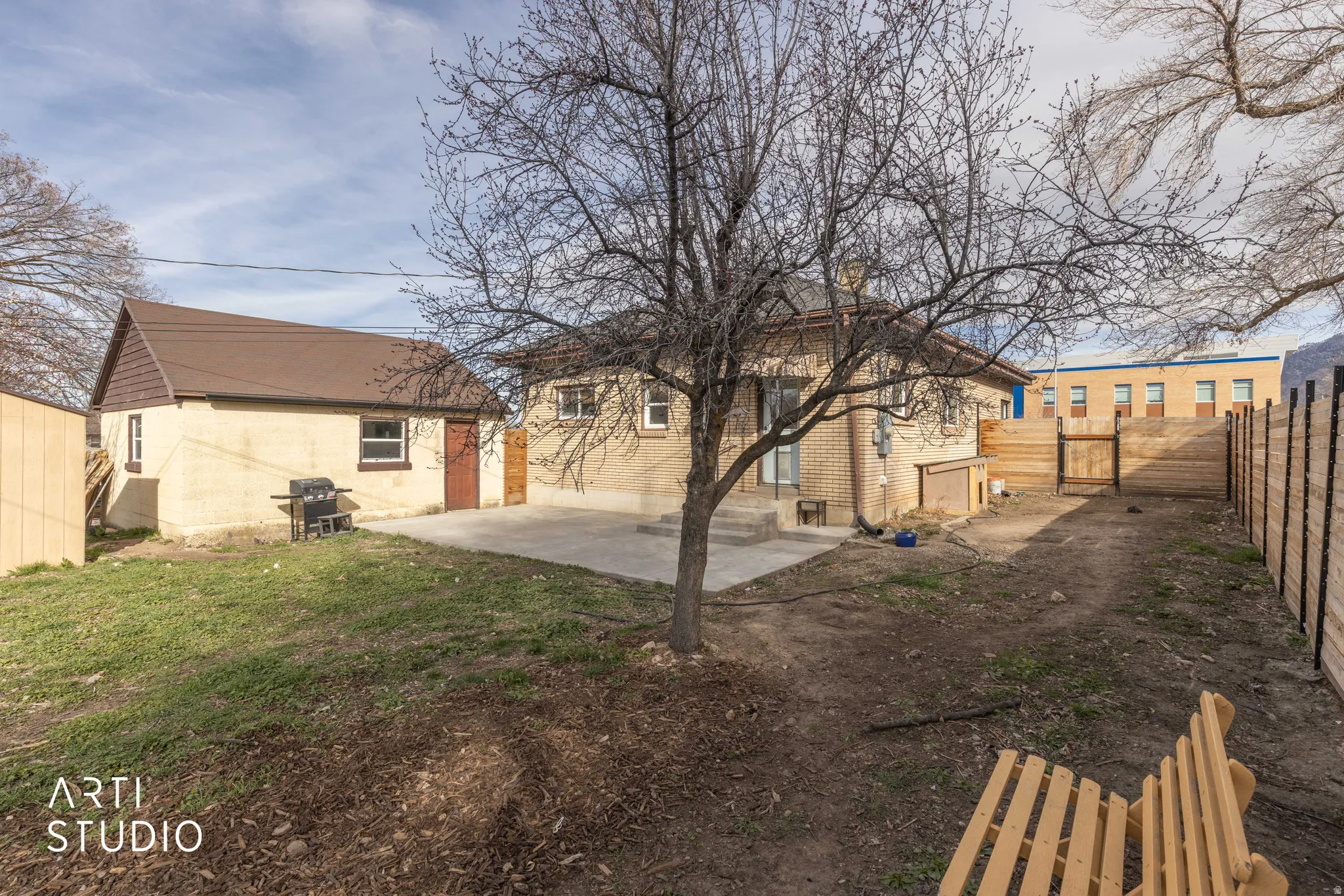 Fenced backyard featuring a gate and a patio