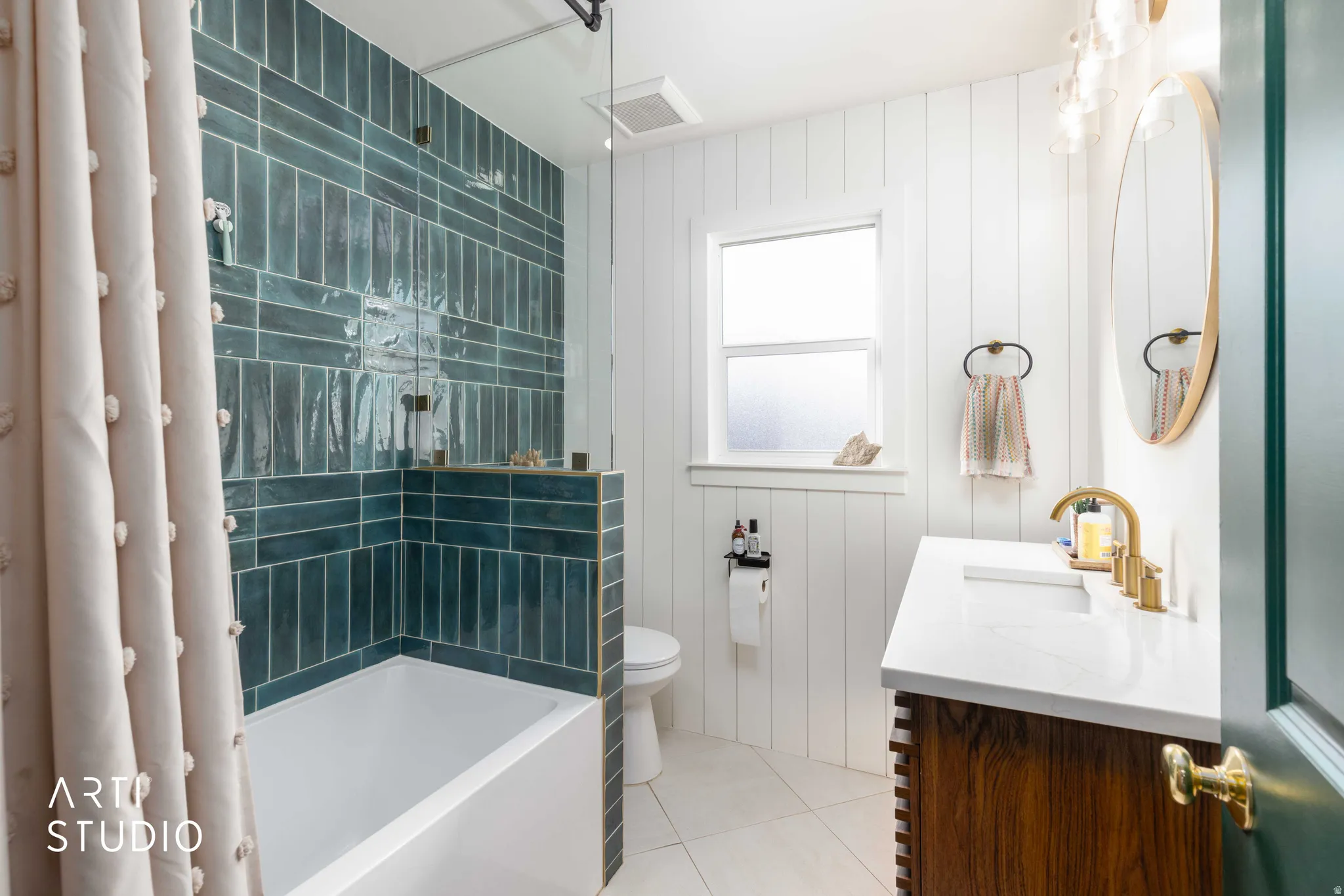 Full bathroom with vanity, light tile patterned floors, shower / tub combo with curtain, and wood walls