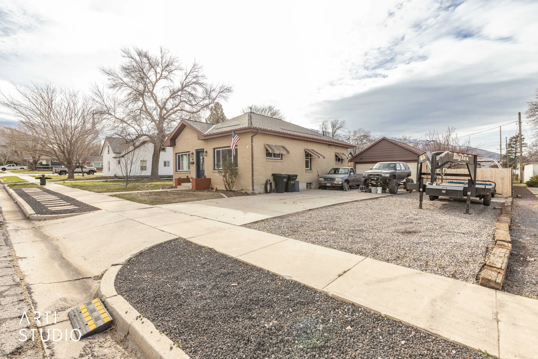 View of side of property with brick siding, a residential view, and driveway