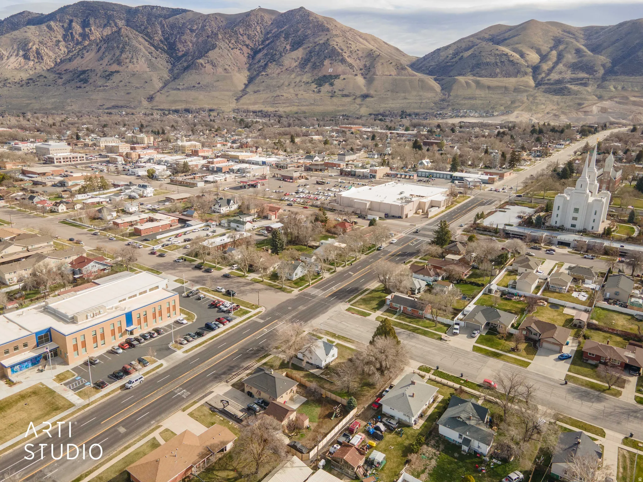 Aerial view of property's location with mountains and nearby suburban area