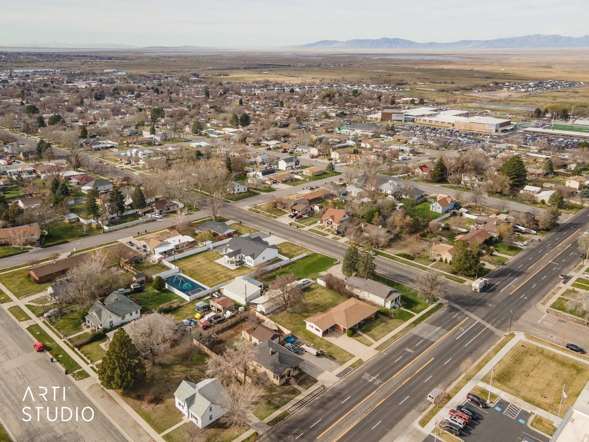 Aerial view of property's location with nearby suburban area and a mountain backdrop