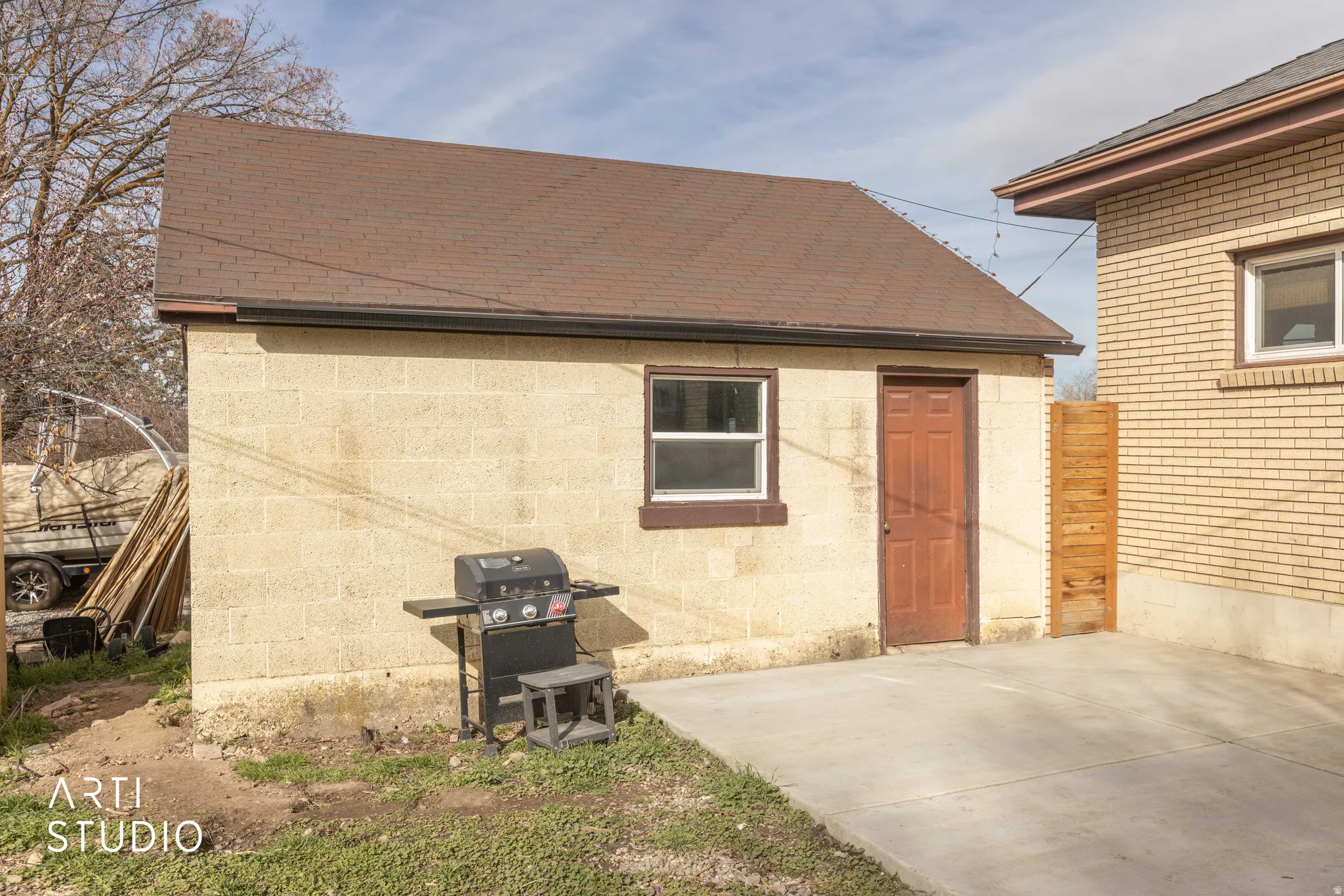 Rear view of property featuring roof with shingles and a patio