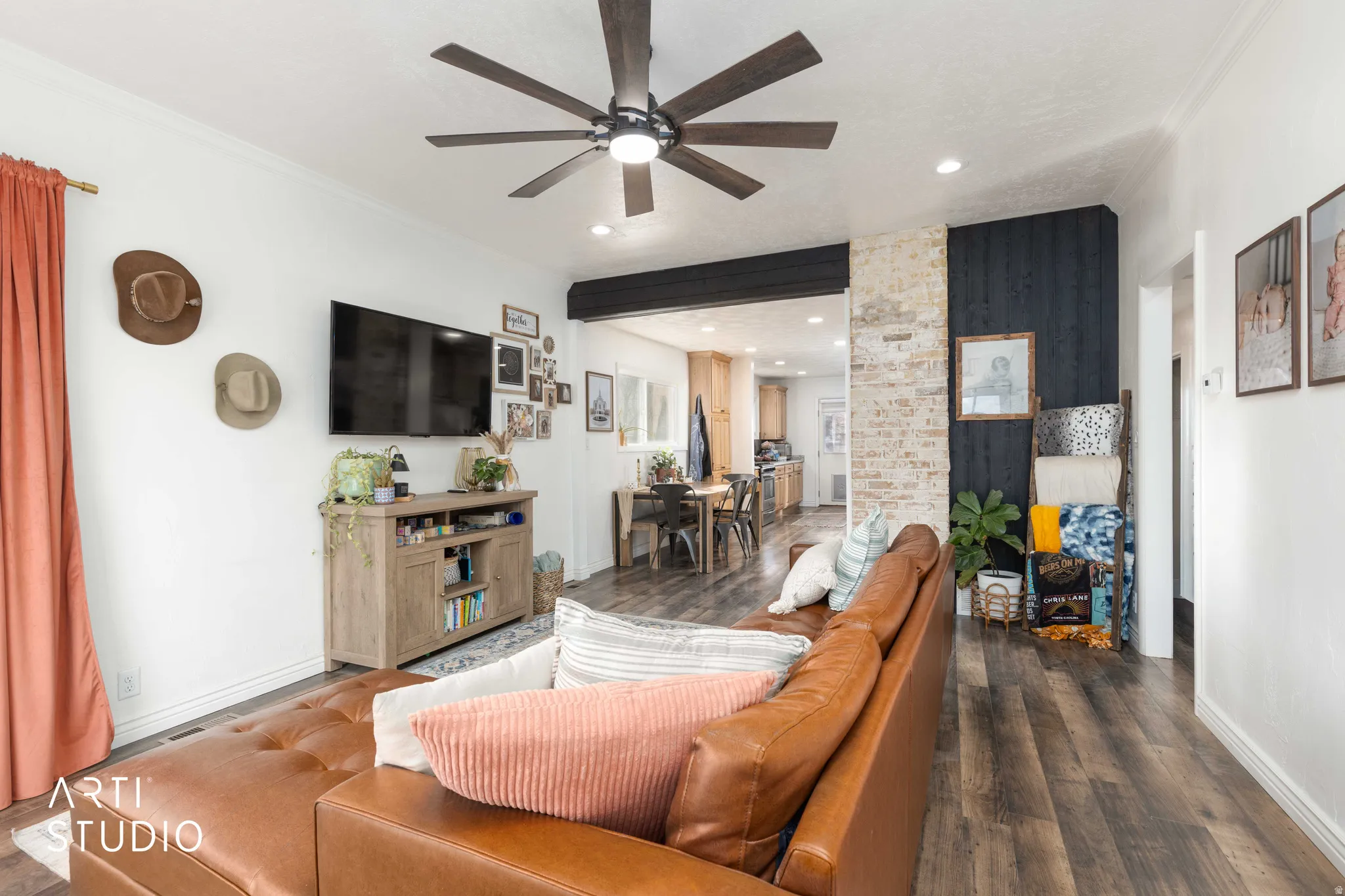 Living room with dark wood-style floors, ceiling fan, crown molding, and recessed lighting
