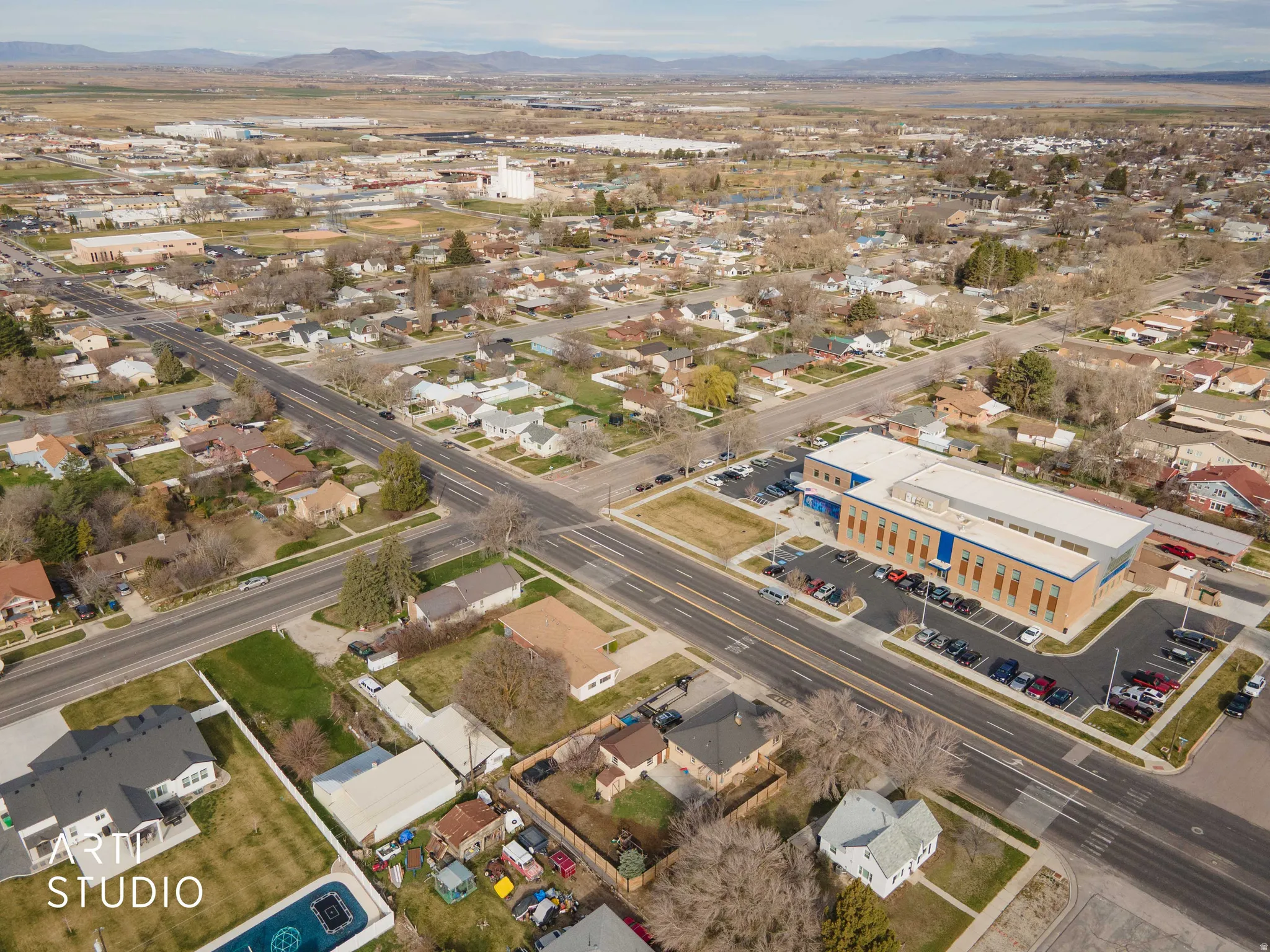 Aerial view of property and surrounding area featuring nearby suburban area