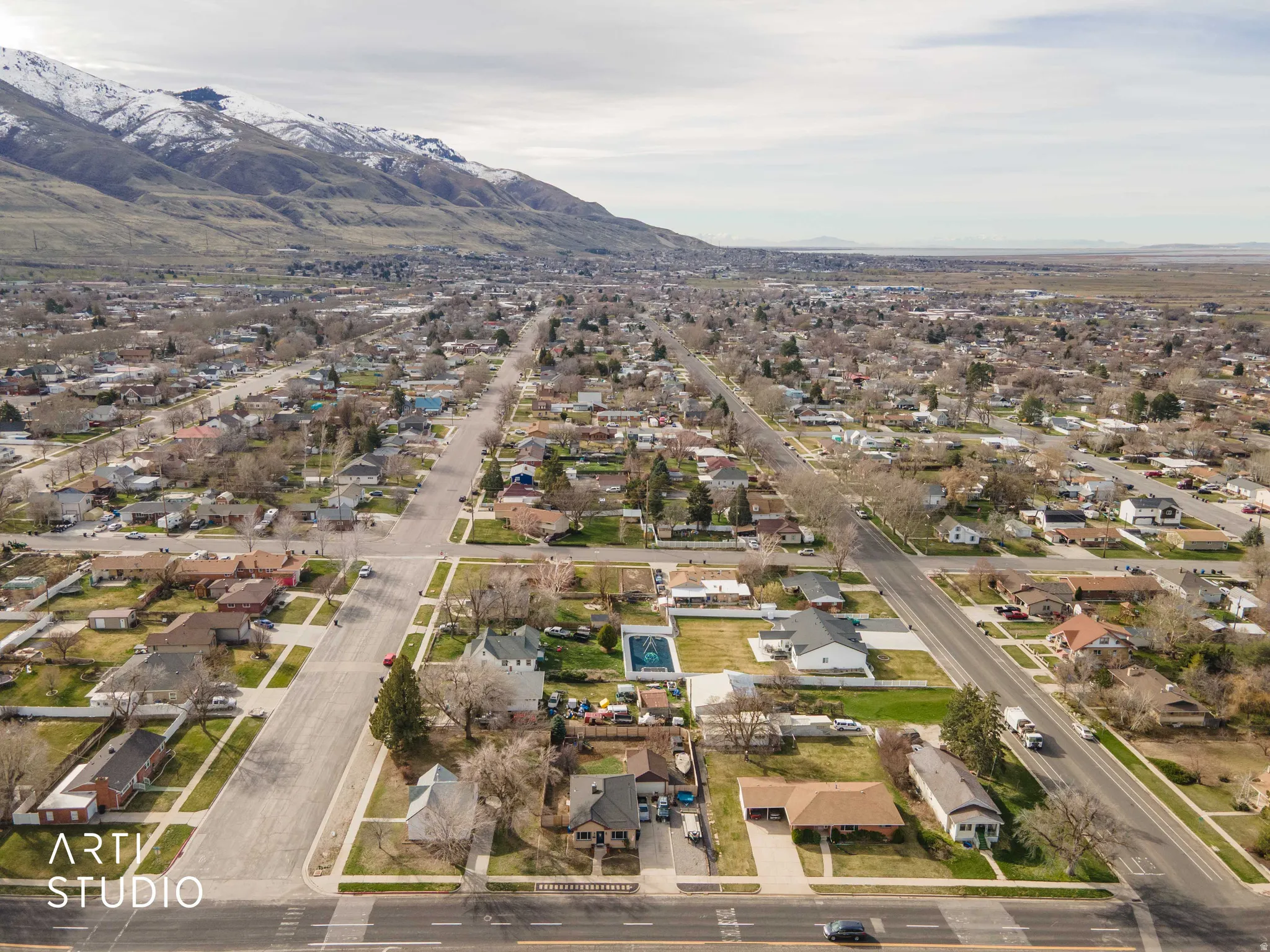 Aerial perspective of suburban area featuring a mountainous background