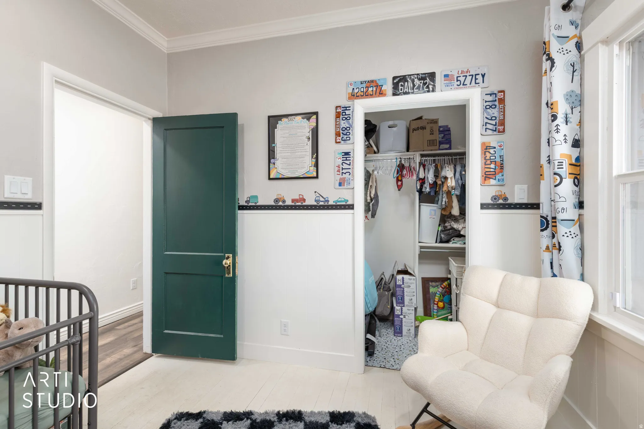 Bedroom featuring a closet, light wood finished floors, and ornamental molding