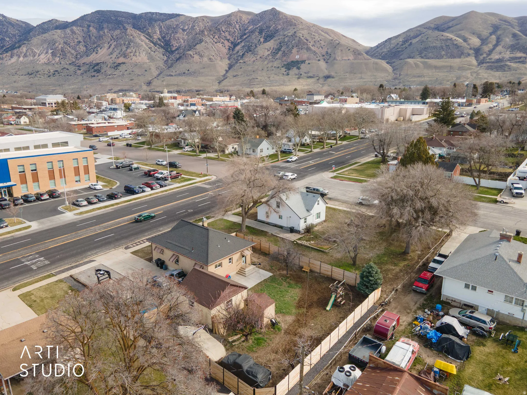 Aerial view of property's location featuring nearby suburban area and a mountain backdrop