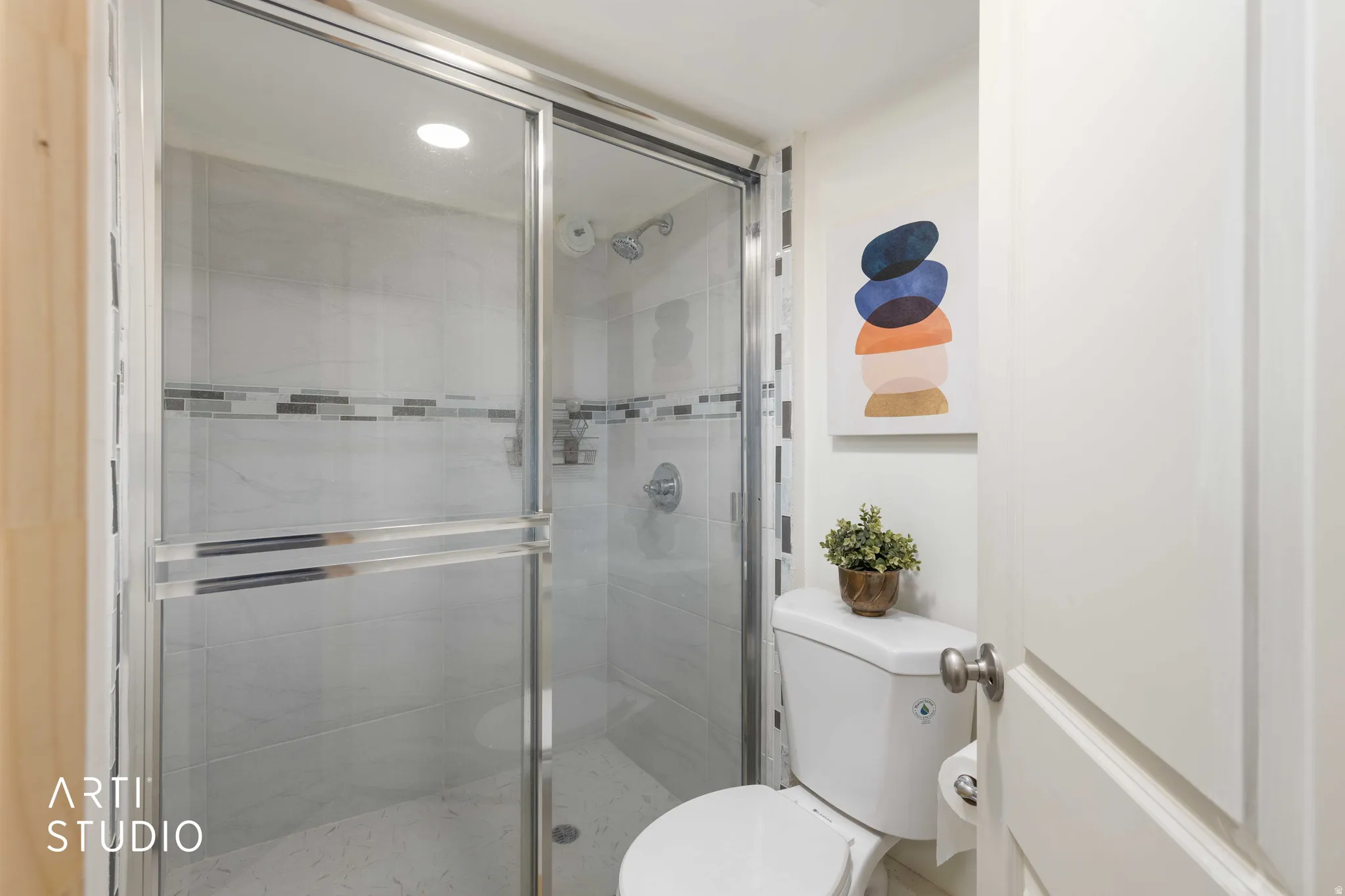 Full bathroom featuring a shower stall and recessed lighting