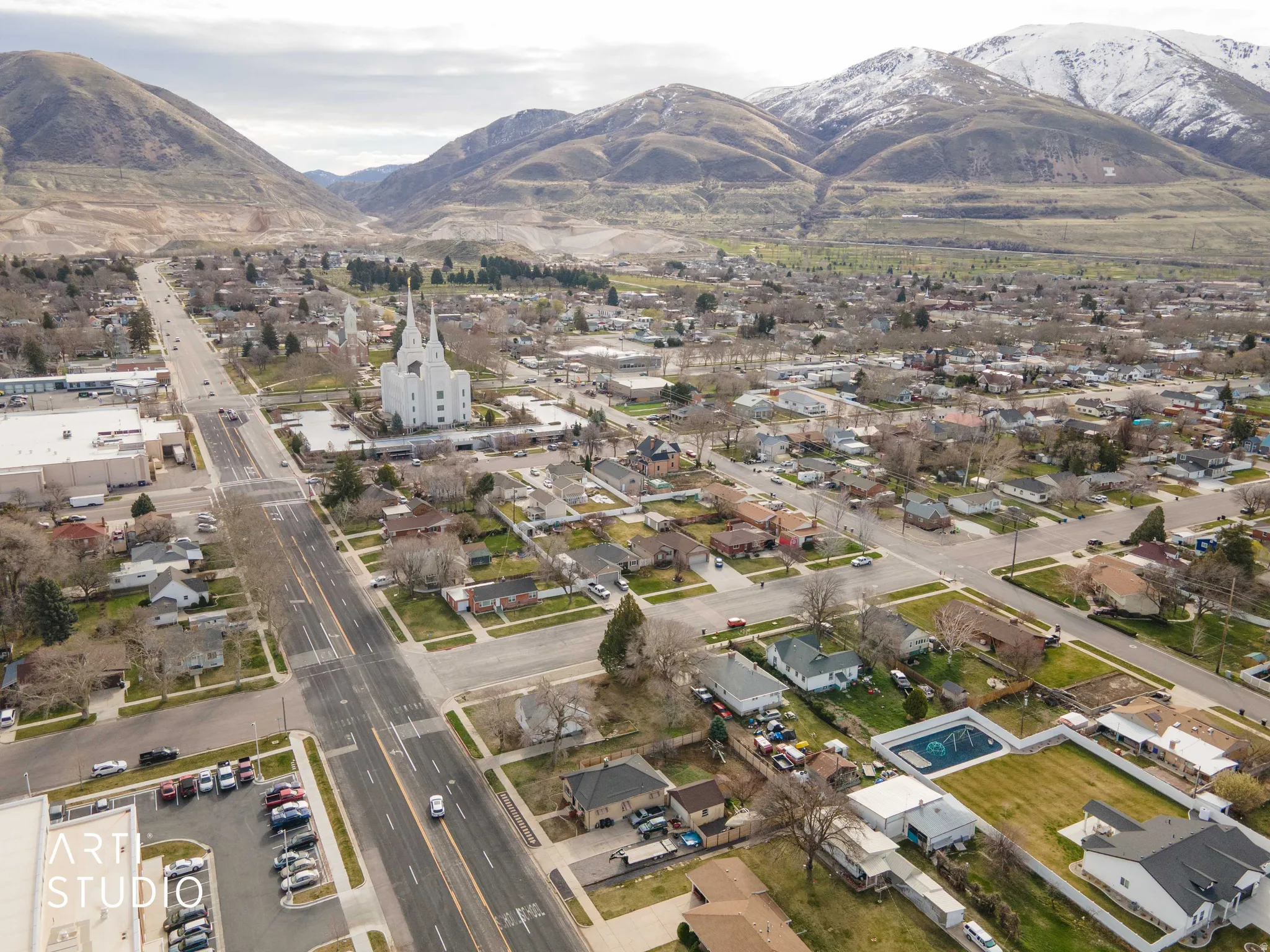 Aerial overview of property's location featuring mountains and nearby suburban area