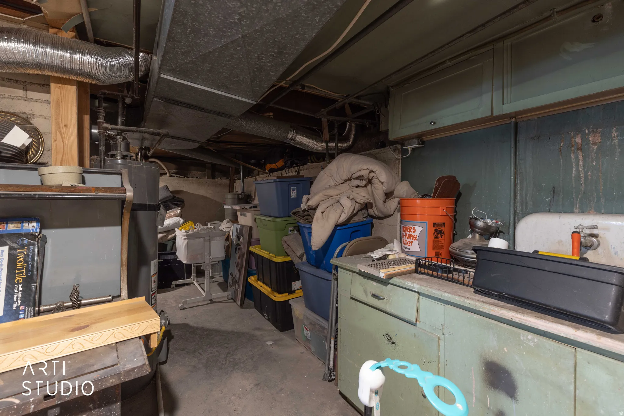 Unfinished below grade area featuring water heater