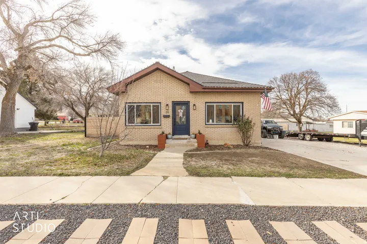 Bungalow featuring brick siding