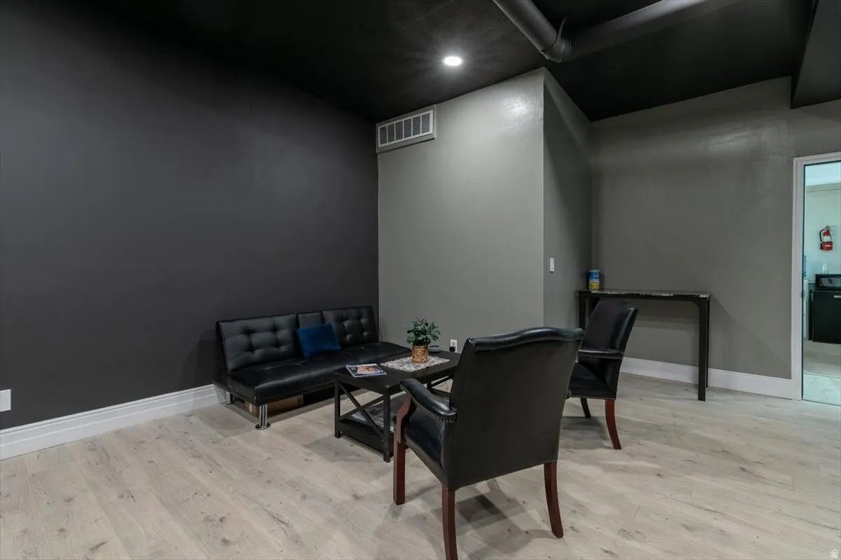 Living area with light wood-style floors and baseboards