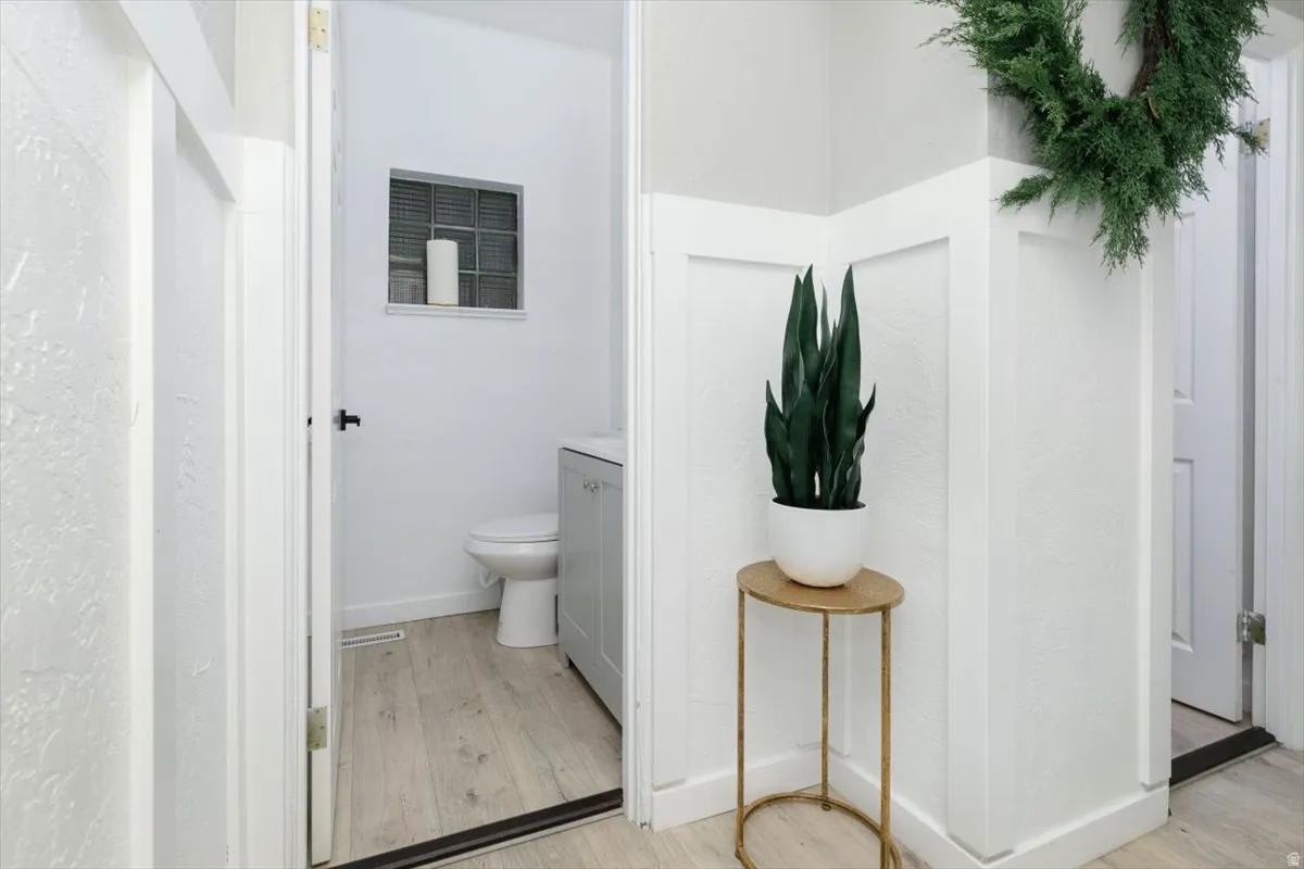 Bathroom with light wood-style flooring and vanity
