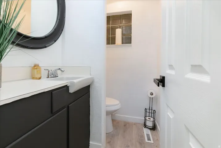 Half bath featuring vanity and light wood-type flooring