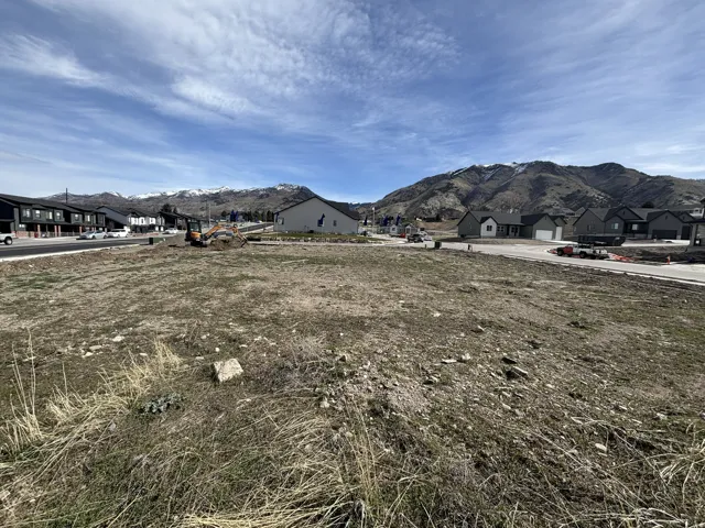 View of mountain backdrop featuring nearby suburban area