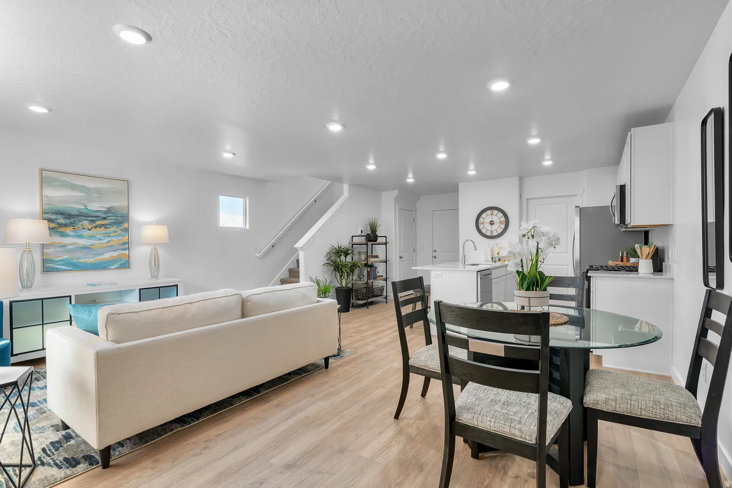 Dining room featuring light wood-style floors, a textured ceiling, and recessed lighting