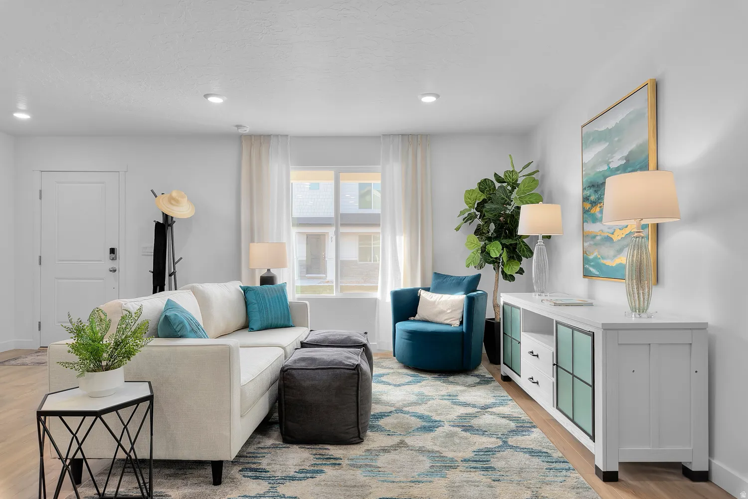 Living room with light wood-type flooring and recessed lighting
