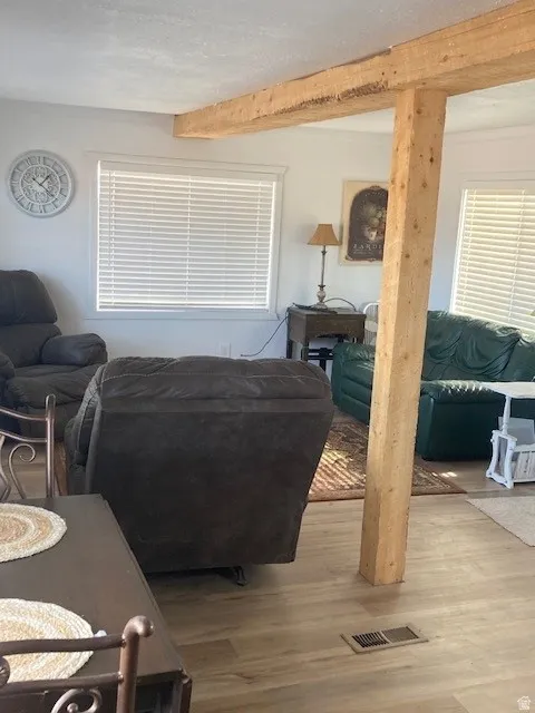 ADU Living Room featuring wood finished floors and beam ceiling