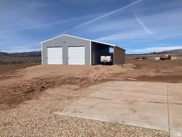 Detached garage with a mountain view and driveway