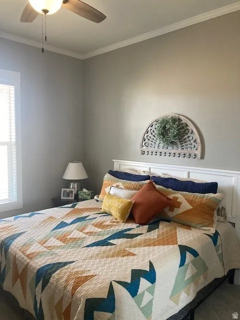 Bedroom featuring crown molding and ceiling fan