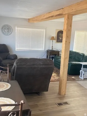 ADU Living Room featuring wood finished floors and beam ceiling