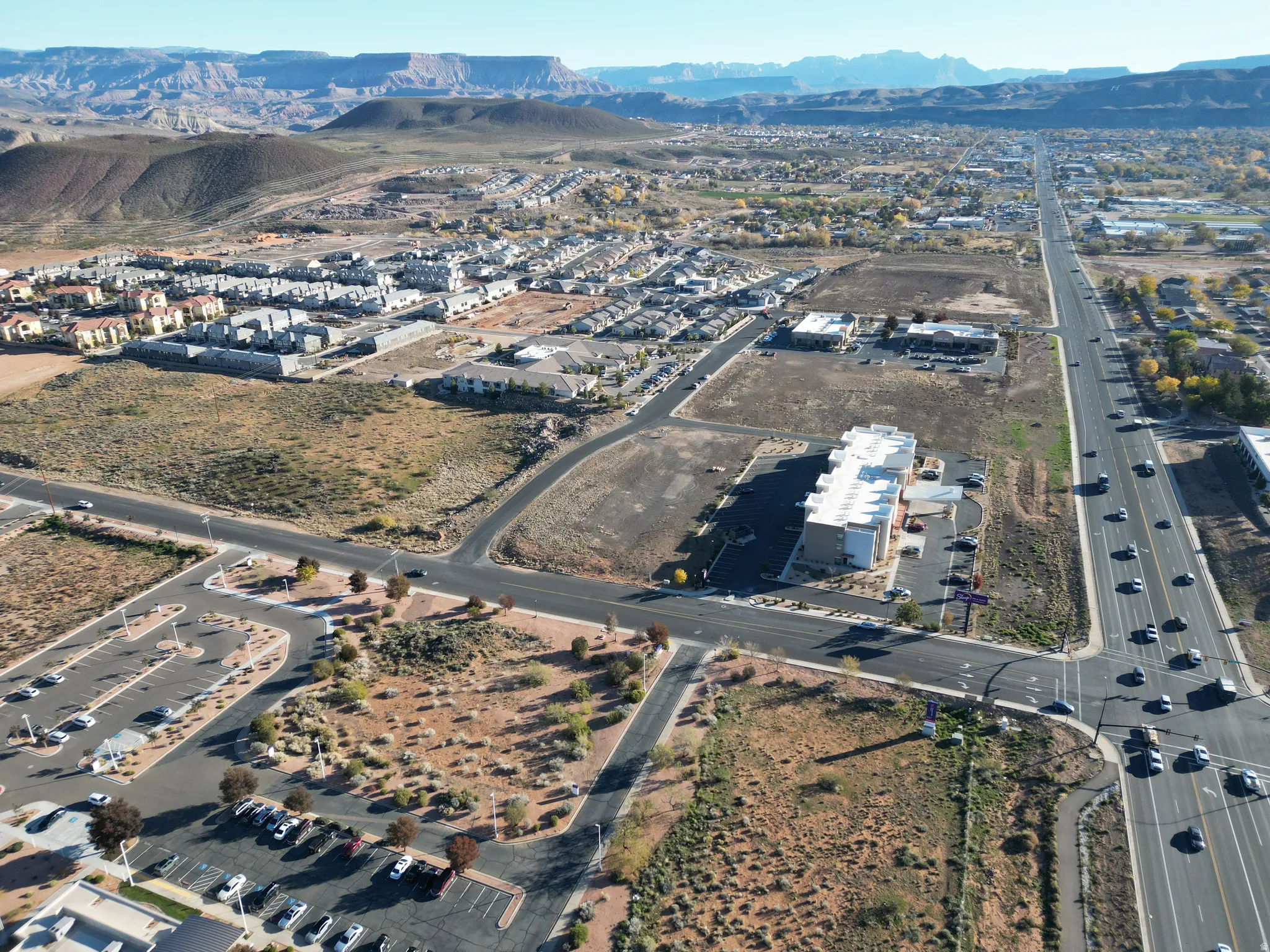 Aerial view of property's location featuring a mountain backdrop and nearby suburban area