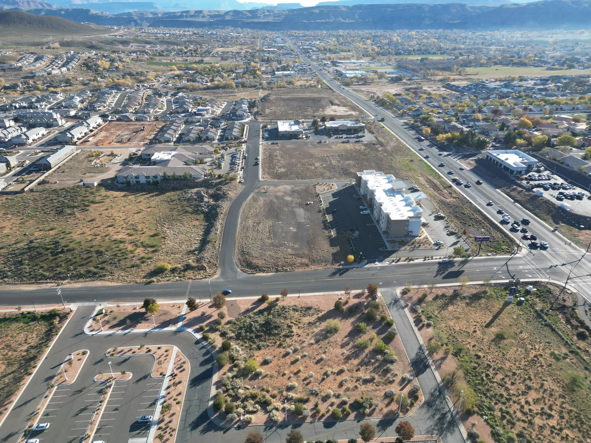 Aerial view of property's location featuring a mountainous background