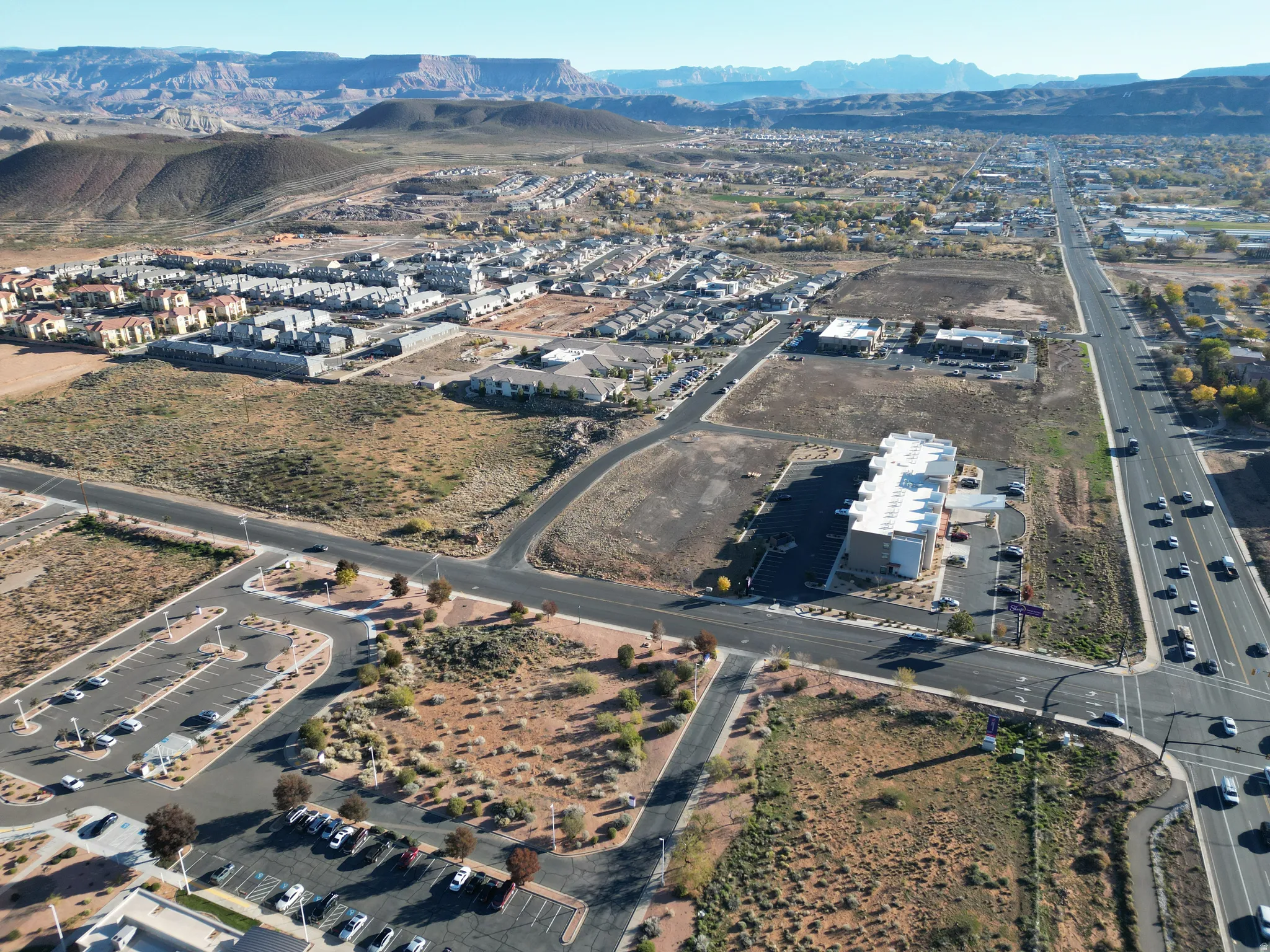 Aerial view of property and surrounding area featuring mountains