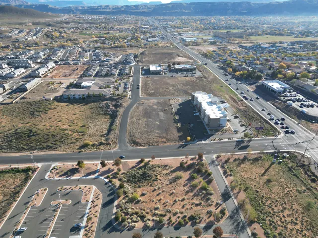 Aerial view of property's location featuring a mountainous background